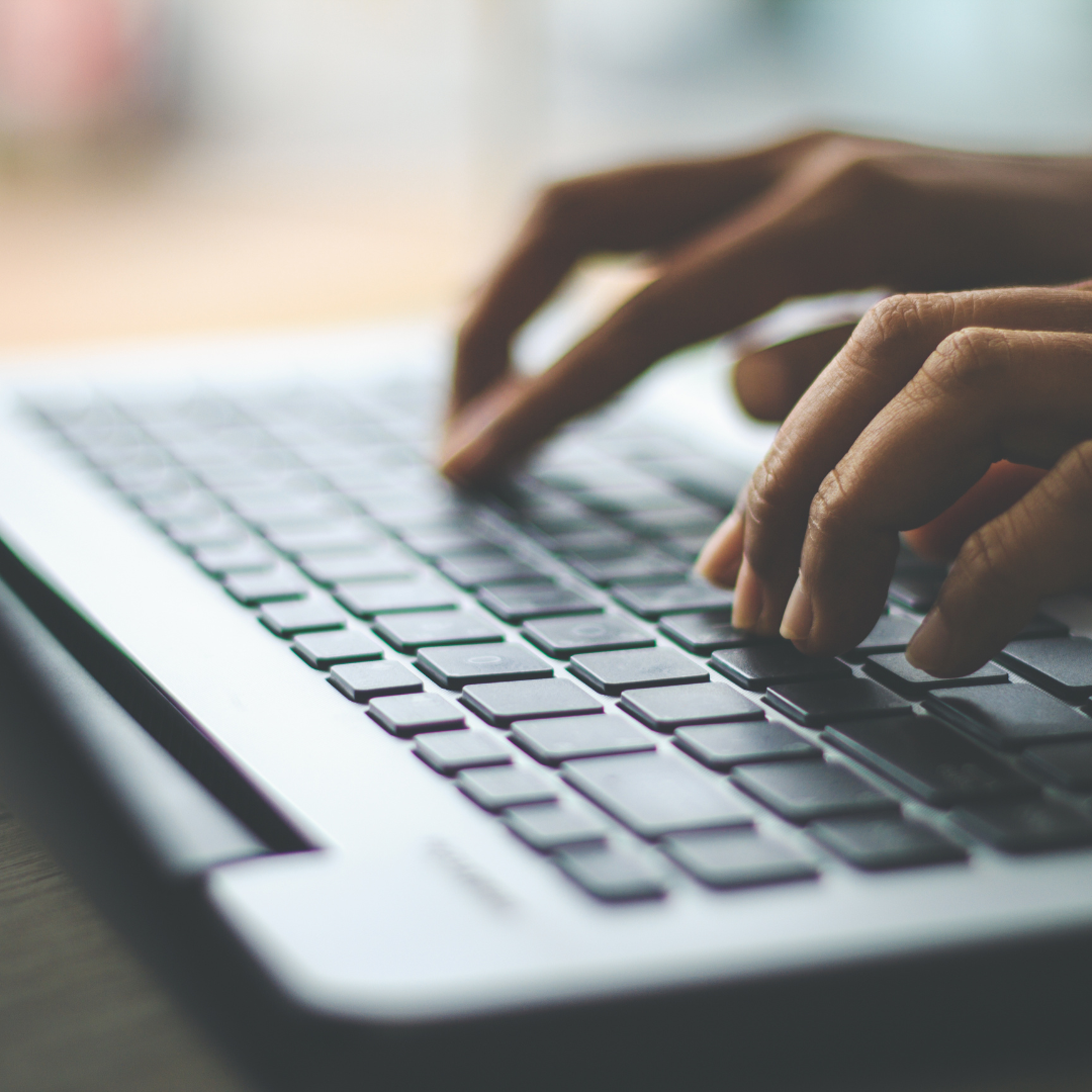 Hands typing on a keyboard
